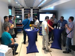 Specialists attending a presentation inside the OMICRON Roadshow truck